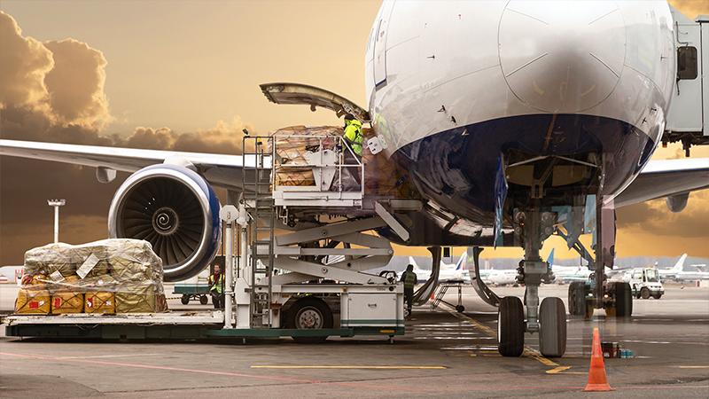 stock-photo-loading-cargo-on-the-plane-in-airport-view-through-window-651052612.jpg